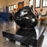 Sculpture en marbre noir représentant une rose en pleine éclosion, aux formes organiques et enveloppantes. Cette œuvre joue avec la matière et la lumière, révélant des courbes profondes et une présence presque sensuelle. Pièce décorative forte, idéale en intérieur comme en extérieur.